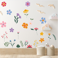 Colorful floral wall decals on a white wall with wooden flooring.
