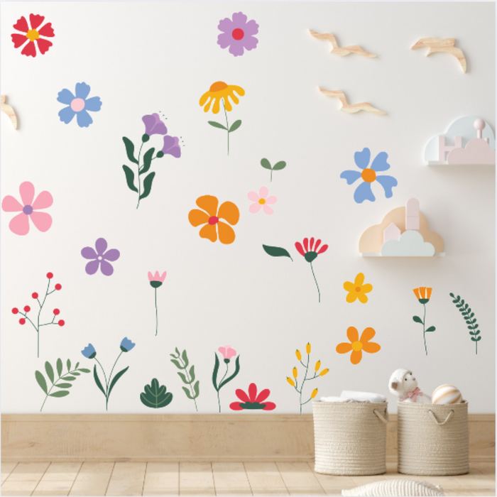 Colorful floral wall decals on a white wall with wooden flooring.