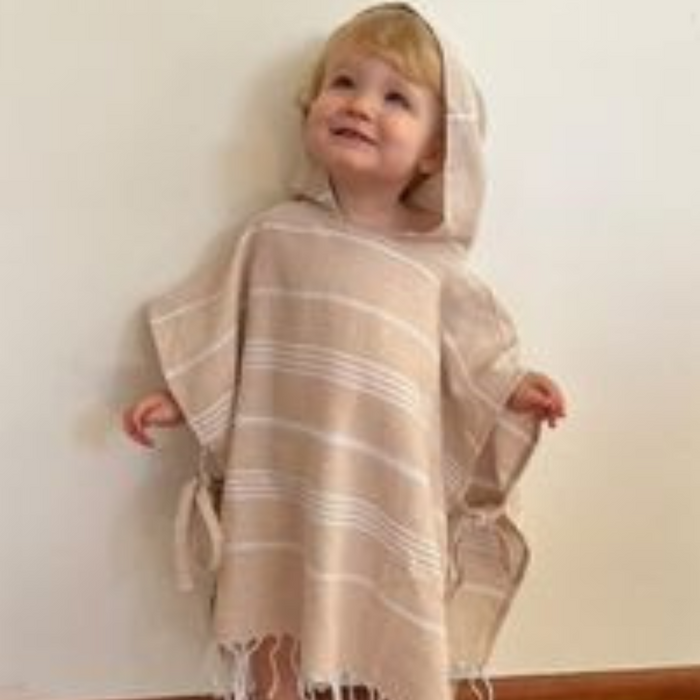 Organic Cotton Poncho Towel: Soft and lightweight poncho towel in vibrant colors, perfect for beach days or poolside fun, featuring ties for adjustable fit.