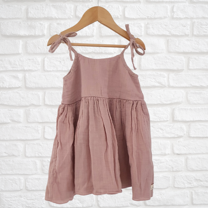 Soft and breathable organic muslin cotton dress with adjustable straps and ruffled hem for kids
