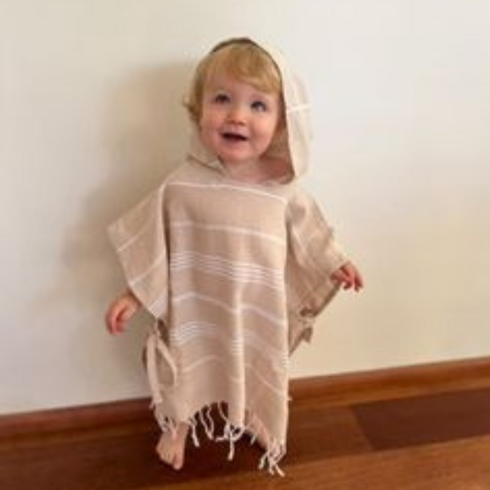 Personalised kids poncho towel featuring a child’s name in elegant script, ideal for making a unique gift.